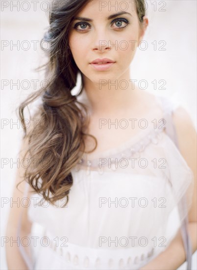 Bride with curled hair in wedding dress