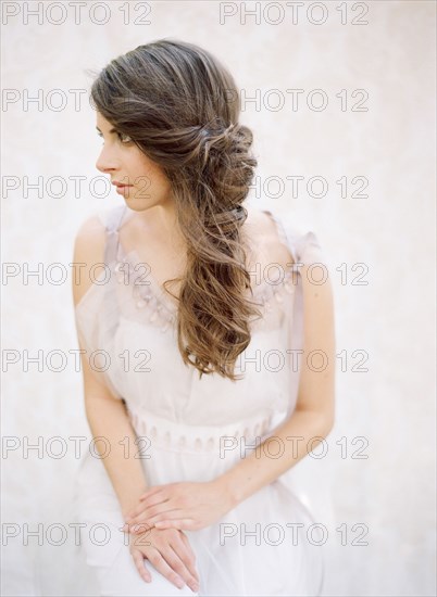 Bride with curled hair in wedding dress