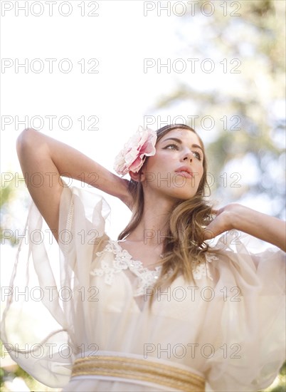 Bride walking under trees