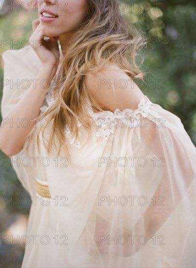 Woman in white dress standing in garden