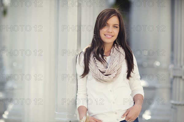 Smiling woman leaning on columns