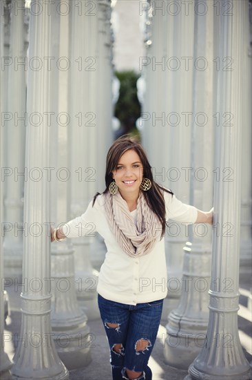 Smiling woman playing in columns