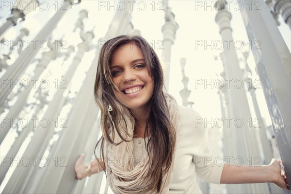 Low angle view of woman leaning on columns