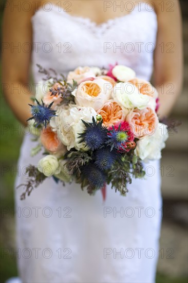 Close up of bride holding bouquet of flowers