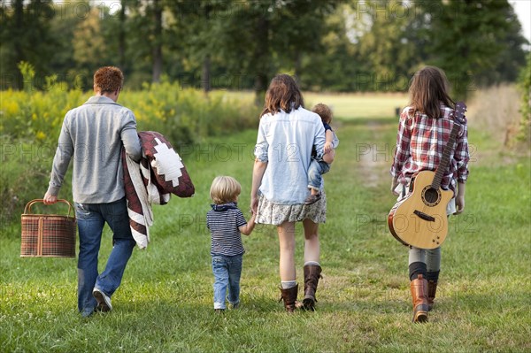 Family walking in rural field