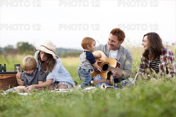 Family having picnic in rural field