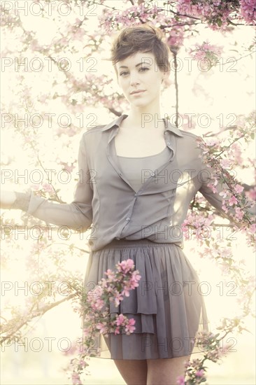 Woman standing in flowering trees