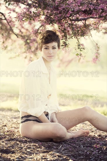 Woman in lingerie under flowering trees