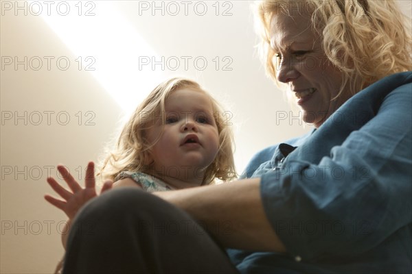 Close up of grandmother holding granddaughter