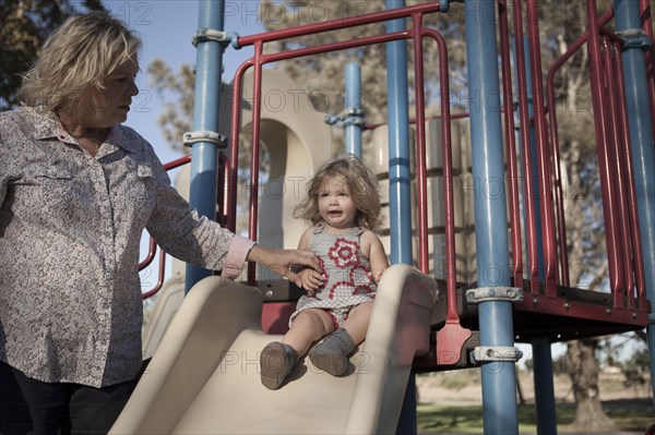 Grandmother and granddaughter playing at playground