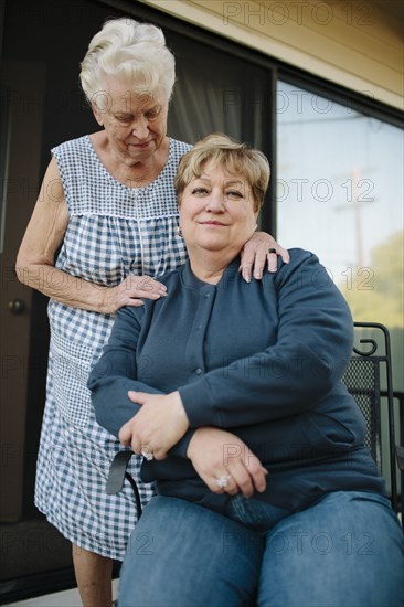 Older woman standing with daughter