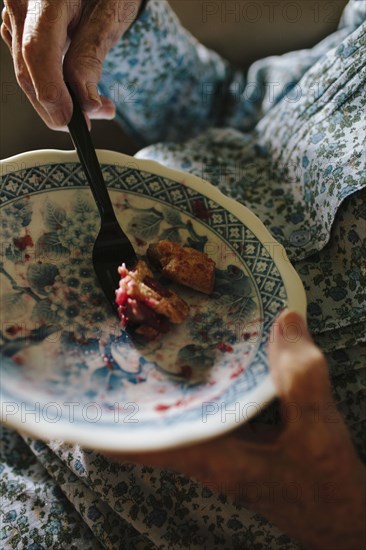 Close up of older mixed race woman eating