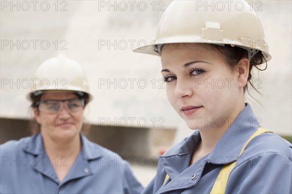 Workers wearing hard-hats and uniforms at work