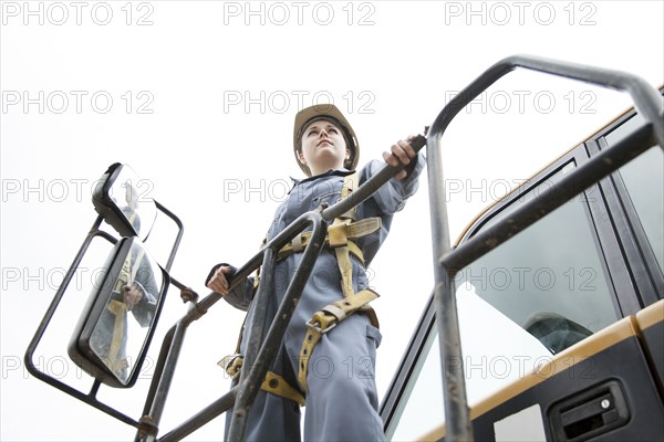 Worker wearing harness at construction site