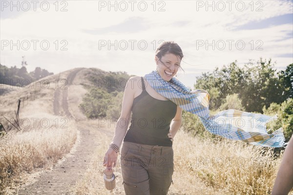 Caucasian woman walking on rural dirt road