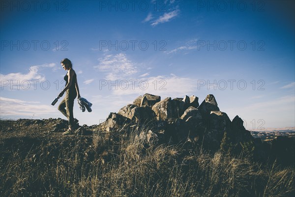 Caucasian woman walking in rural field