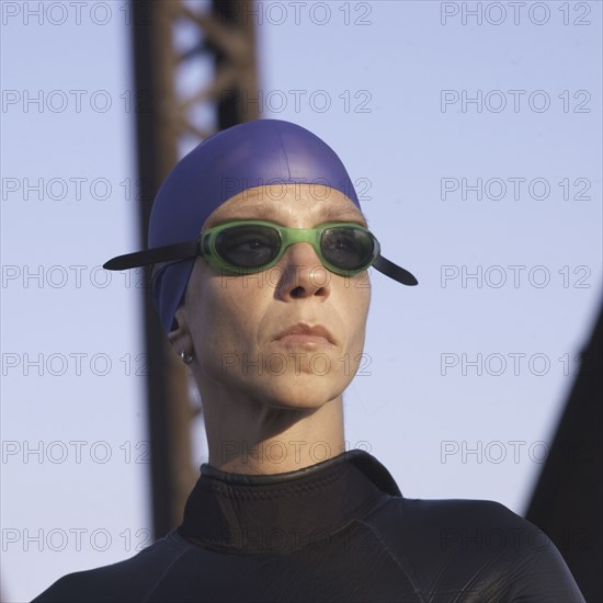 Close up of Caucasian swimmer wearing goggles and wetsuit