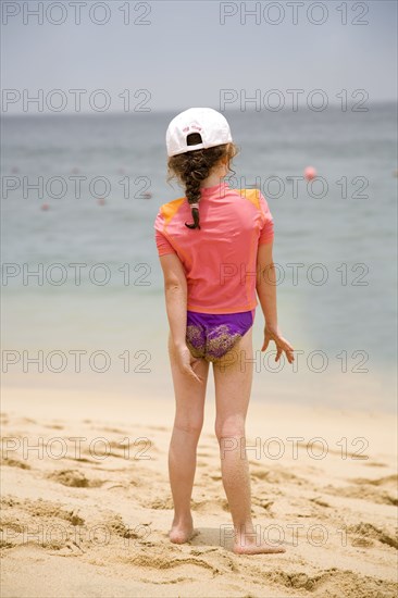 Caucasian girl walking on beach