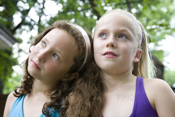 Pensive Caucasian girls standing outdoors