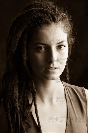 Close up of serious woman with dreadlocks