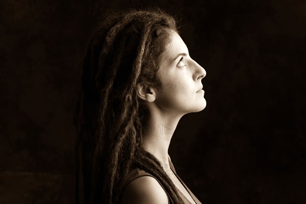 Close up profile of serious woman with dreadlocks