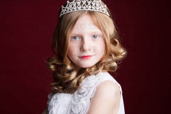 Caucasian girl wearing tiara and princess costume