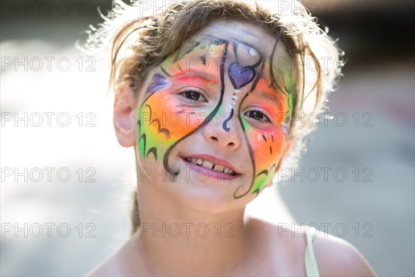 Close up of smiling Caucasian girl with face paint