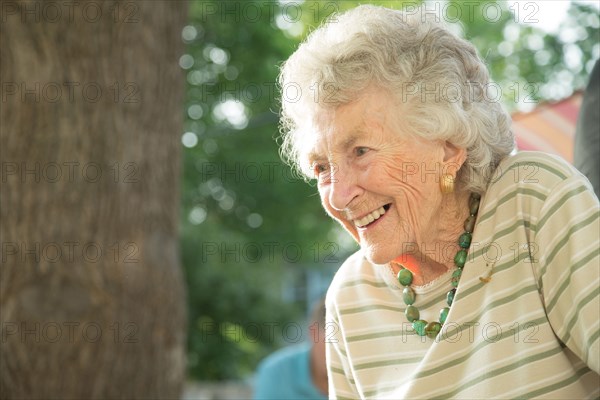 Close up of older woman smiling outdoors