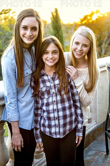 Caucasian teenage girls smiling on patio