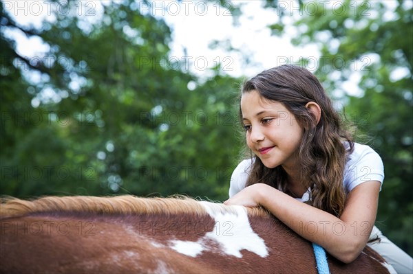 Close up of teenage girl riding horse