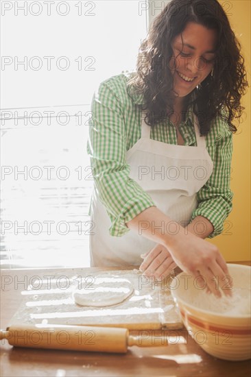 Baker rolling dough on counter