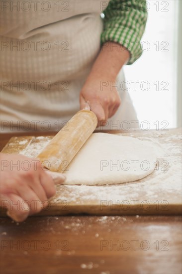 Baker rolling dough on counter