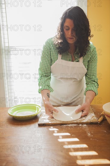 Baker rolling dough on counter