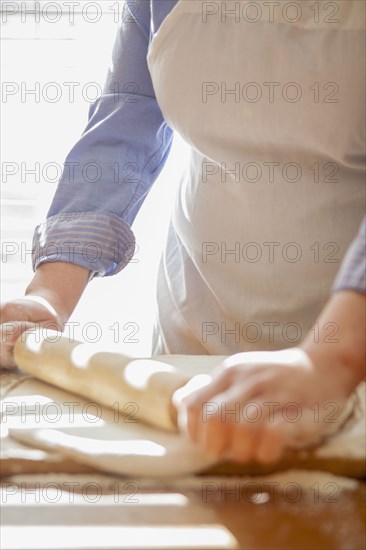 Baker rolling dough on counter