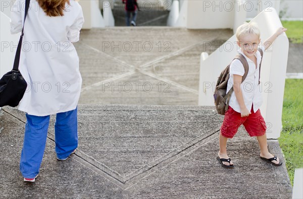 Doctor and son walking on steps