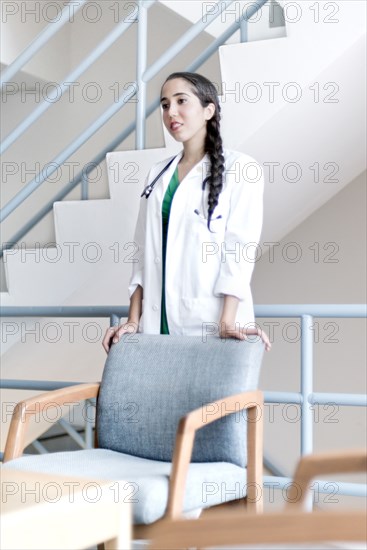 Armenian doctor standing at armchair