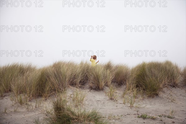 Mixed race girl exploring beach