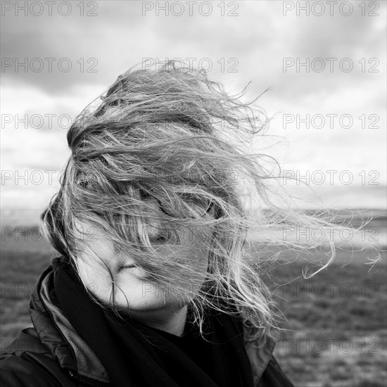 Caucasian woman with hair blowing in wind