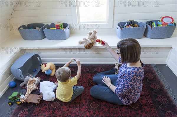 Mother and son playing on floor