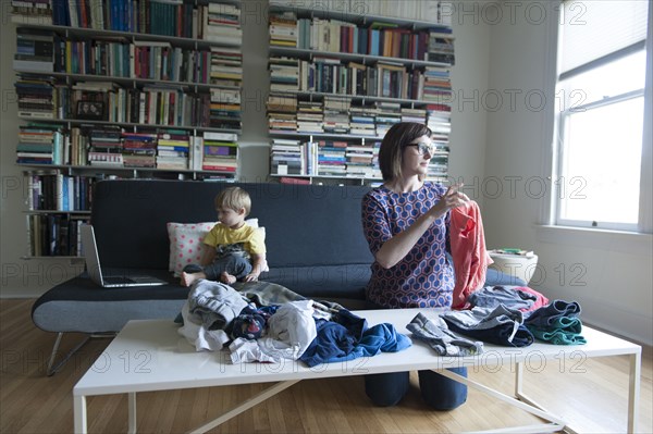 Mother and son folding laundry