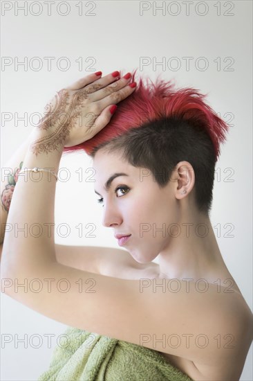 Caucasian woman styling dyed hair