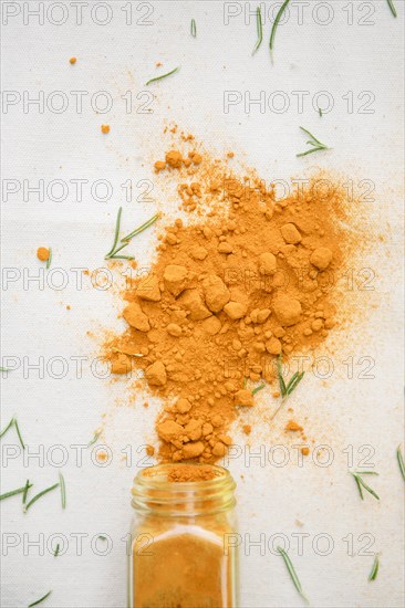 Jar of spilled spices and herbs