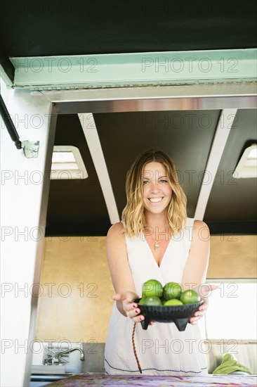 Caucasian woman with bowl of fruit