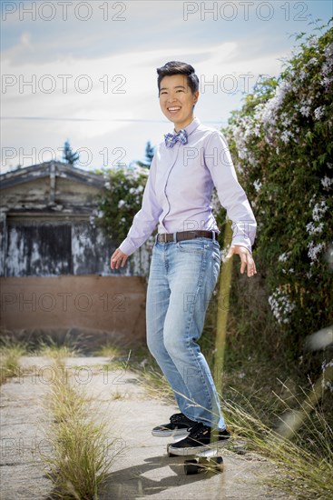 Androgynous woman riding skateboard