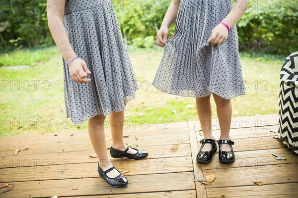 Twin sisters standing on deck