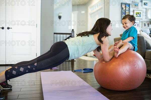 Mother and son playing with exercise ball