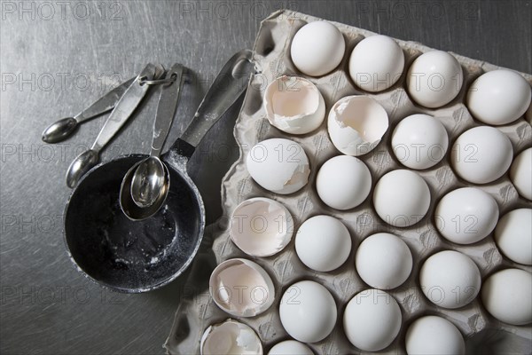 Carton of eggs with measuring spoons