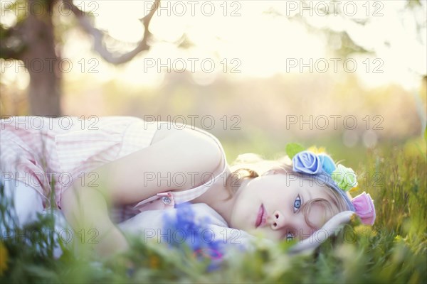 Caucasian girl laying in grass