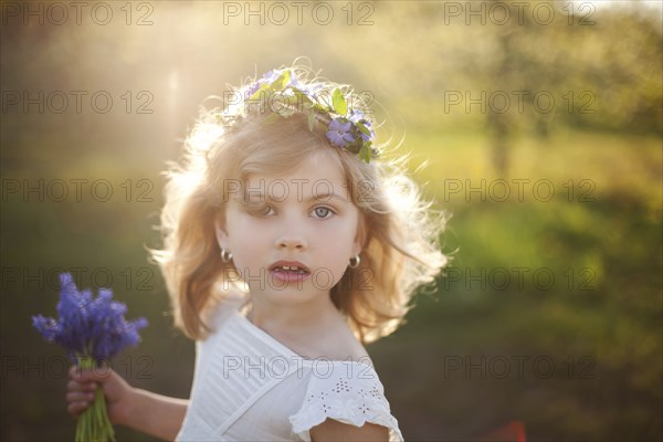 Caucasian girl carrying flowers outdoors