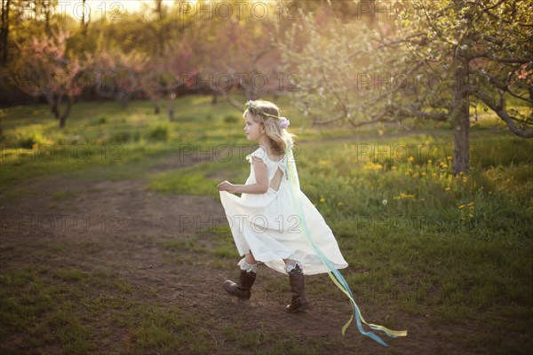 Caucasian girl walking on dirt path